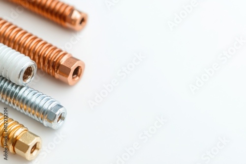Obraz na płótnie bolts on a plain white background, The straightforward lighting highlights the distinct textures and colors of the whole bolts form. w salonie