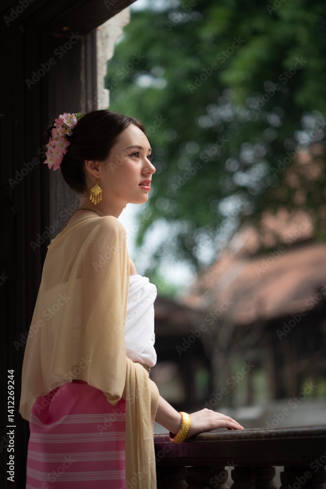 Beautiful young Asean woman in traditional Thai Dvaravati dress in an old temple in Chiang Mai, Thailand.