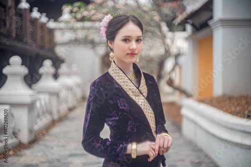 Obraz na płótnie Beautiful young Asean woman in traditional Thai Dvaravati dress in an old temple in Chiang Mai, Thailand. w salonie