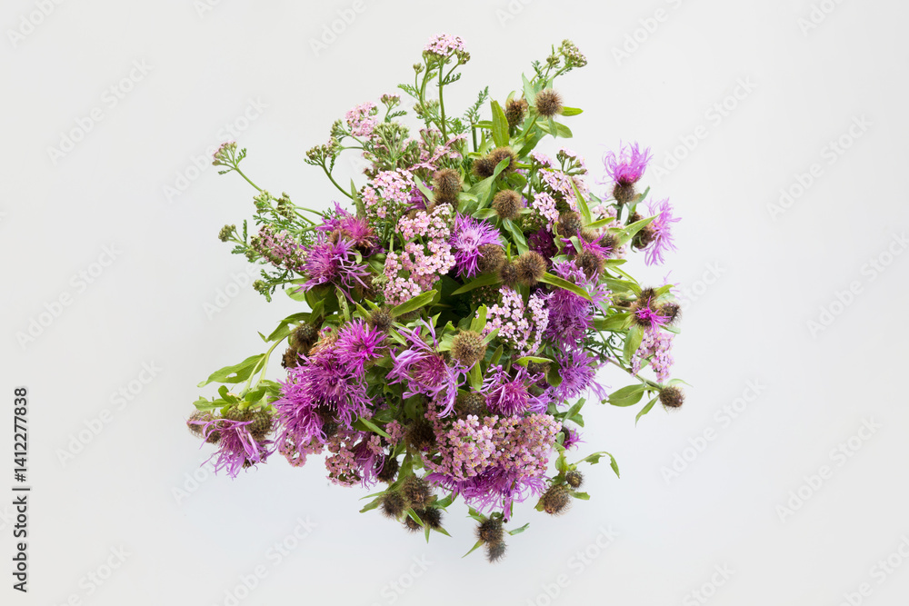 Bouquet of wild purple flowers on grey background. View from above. Close up.