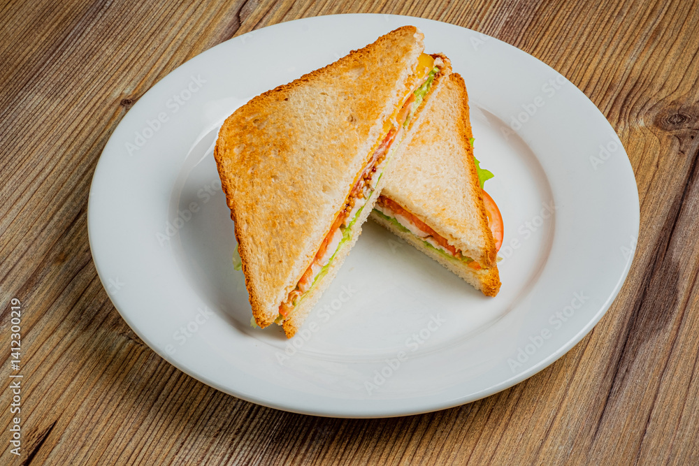 Freshly made sandwich showcases layers of crisp lettuce, tomato, and rich flavors on toasted bread