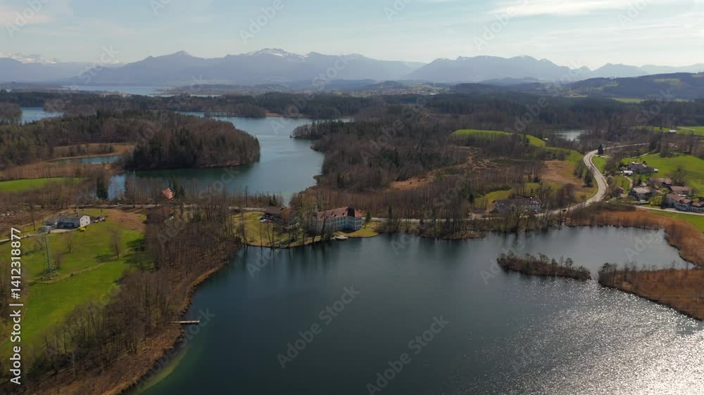 Scenic aerial view of Schloss Hartmannsberg, a former moated castle nestled between Schlosssee and Langbuergner See in Bavaria. A charming blend of history and nature near Bad Endorf, Germany. Scenic aerial view of Schloss Hartmannsberg, a former moated castle nestled between Schlosssee and Langbuergner See in Bavaria. A charming blend of history and nature near Bad Endorf, Germany.