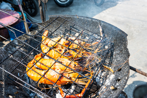 Big river prawn shrimp grilled on fire with smoke