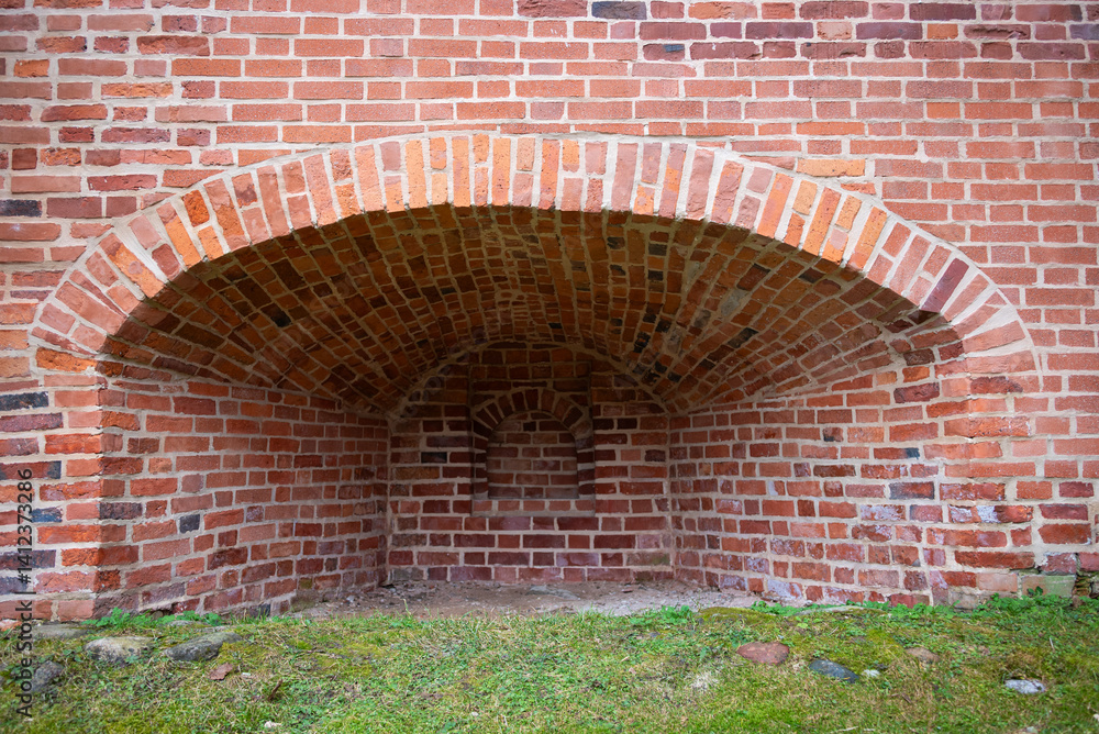 Brick oven in old, vacant building with empty interior.