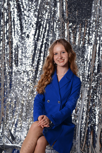 Elegant woman in blue blazer with sparkling background