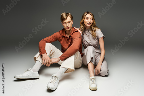 Obraz na płótnie Spring fashion inspiration featuring a young couple in a stylish studio setting w salonie