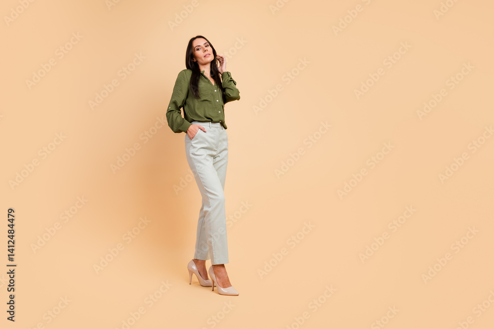 Fototapeta premium Elegant woman in classic outfit posing confidently in an indoor setting, demonstrating professional style and sophistication