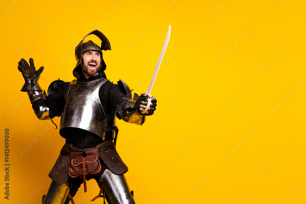 Naklejka premium Young man posing as a medieval knight against a vibrant yellow backdrop