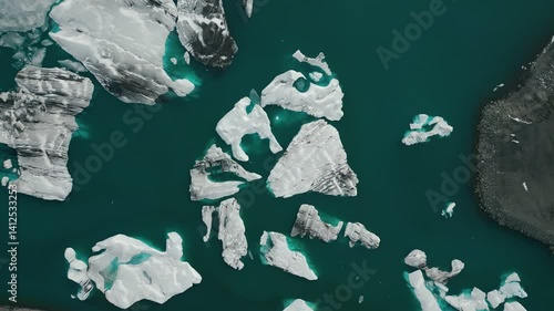 Jökulsárlón Glacier Lagoon, Iceland - 4K Aerial Top Down View of Blue Icebergs Clusters Floating in Deep Blue Water - Slow Orbit Movement - Vatnajökull National Park, Vatnajökulsþjóðgarður