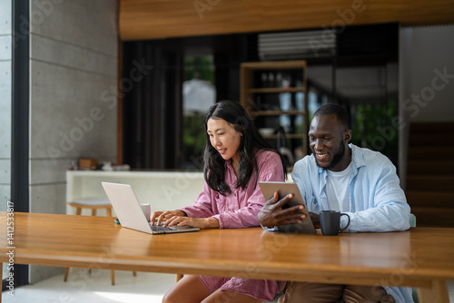 Man and woman working remotely using laptop. Male female freelancers working together. Digital nomad