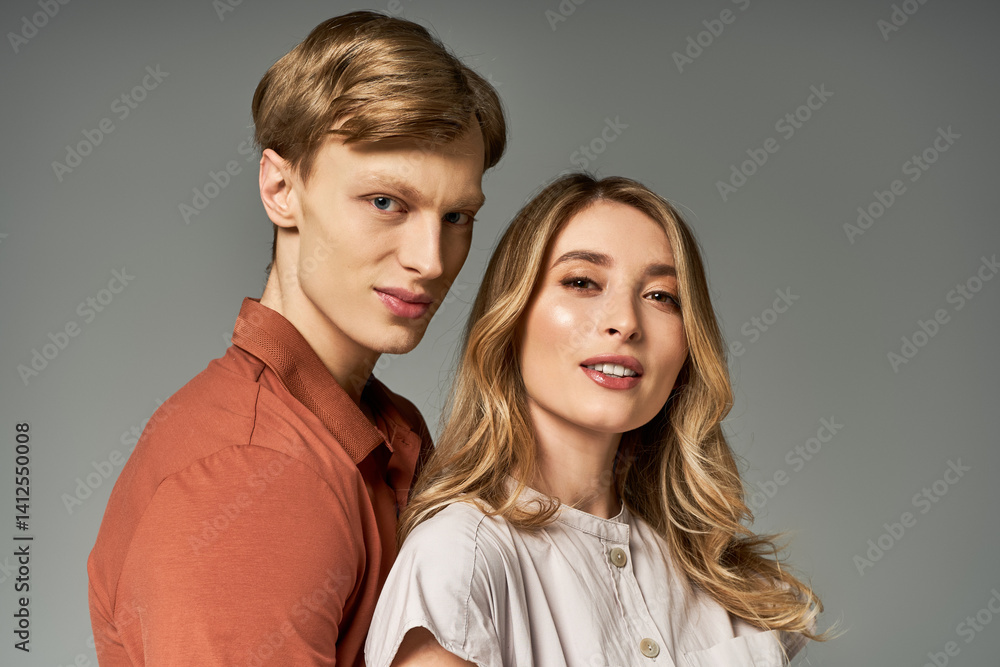 Stylish young couple in spring outfits showcases modern fashion in studio setting Stylish young couple in spring outfits showcases modern fashion in studio setting