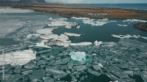 South Iceland - 4K Drone Cinematic Aerial View of Jökulsárlón Glacier Lagoon, the Sea and the Settlement - Vatnajökull National Park, Vatnajökulsþjóðgarður - floating icebergs