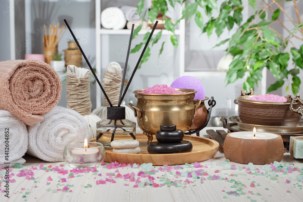 Spa treatment with candles and towel on wooden table, close up