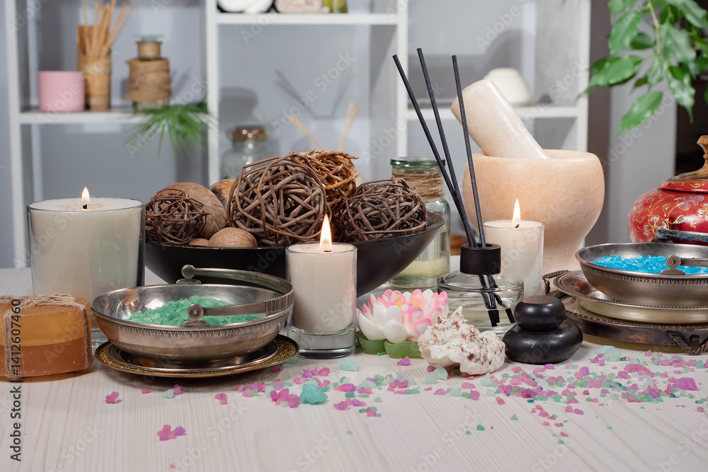 Spa treatment with candles and towel on wooden table, closeup