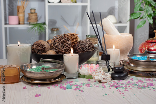 Spa treatment with candles and towel on wooden table, closeup