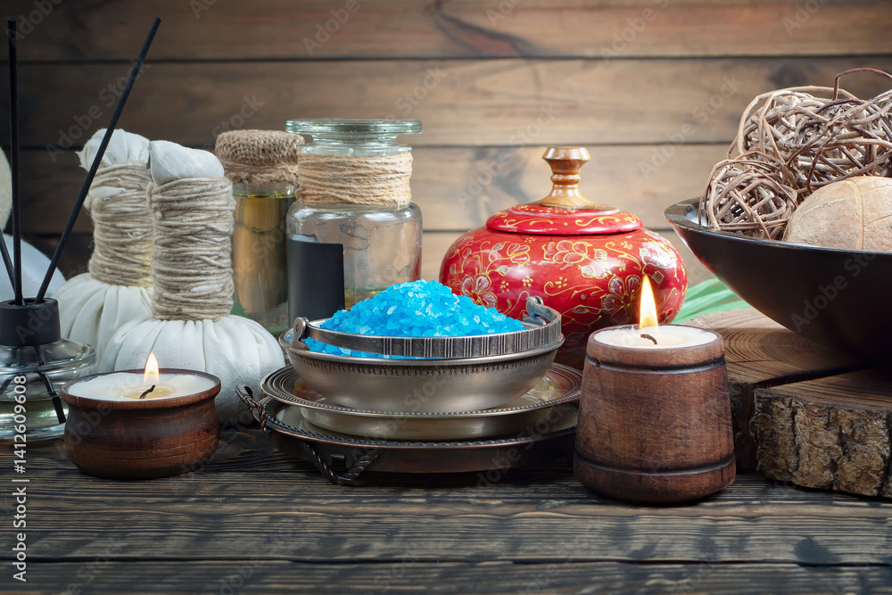 Spa treatment with candles and towel on wooden table, closeup