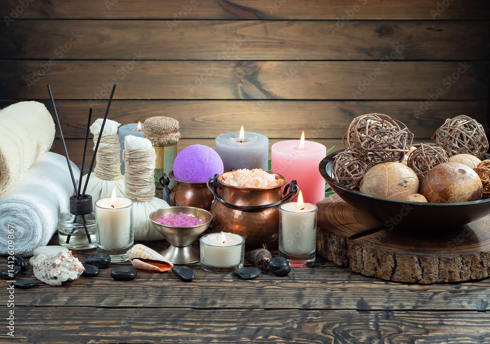 Spa treatment with candles and towel on wooden table, closeup