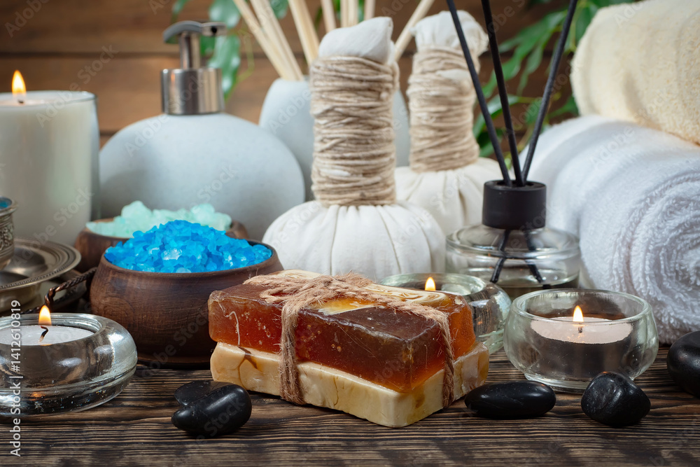 Spa treatment with candles and towel on wooden table, closeup