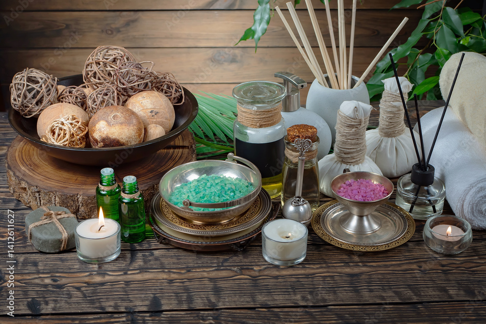 Spa treatment with candles and towel on wooden table, closeup