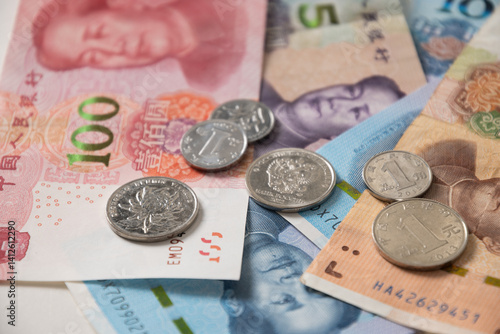 Many of different Chinese yuan banknotes. Chinese paper currency Yuan renminbi banknotes and coins as background.