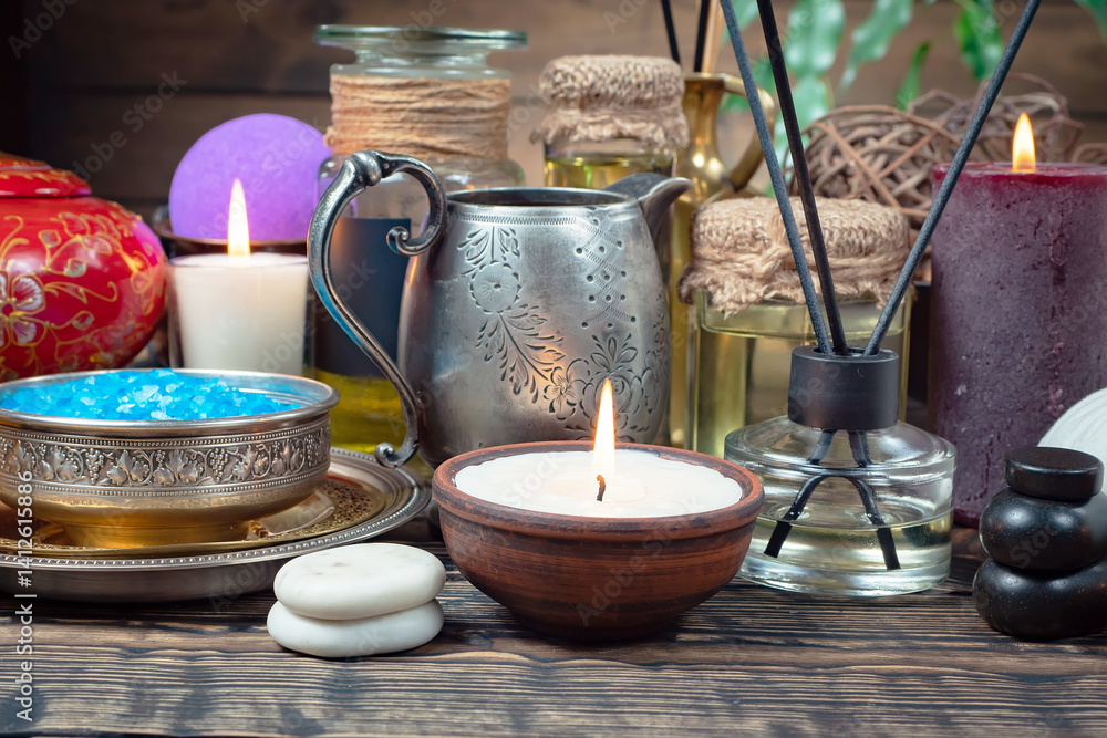 Spa treatment with candles and towel on wooden table, closeup