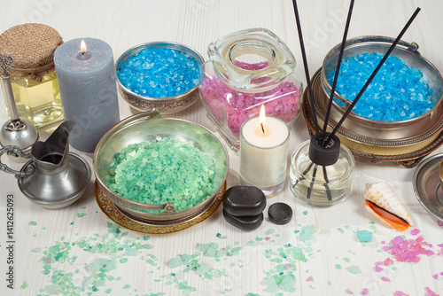 Spa treatment with candles and towel on wooden table, closeup
