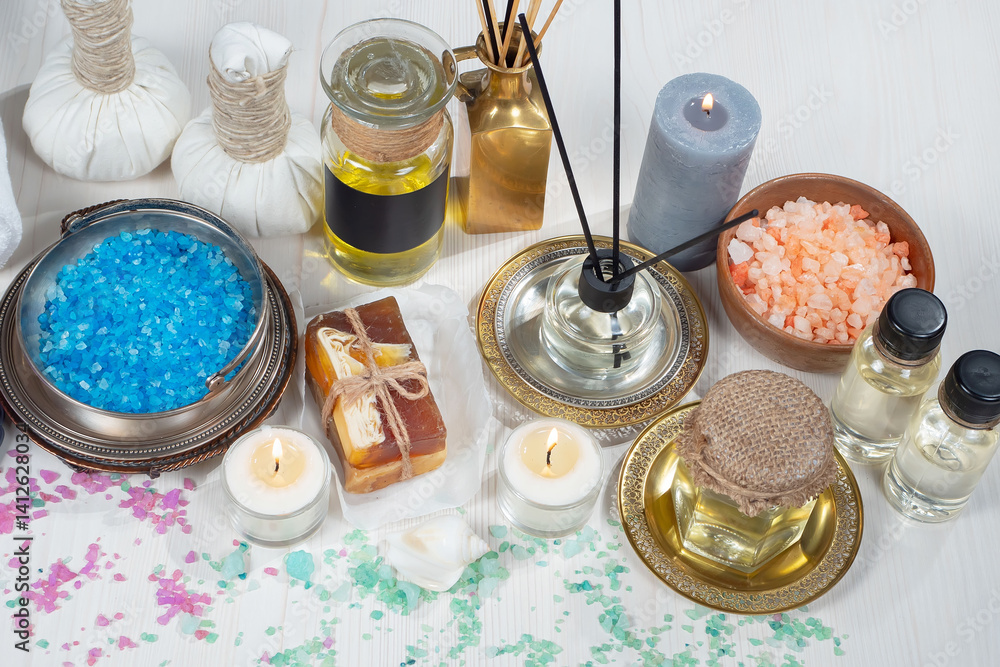 Spa treatment with candles and towel on wooden table, closeup