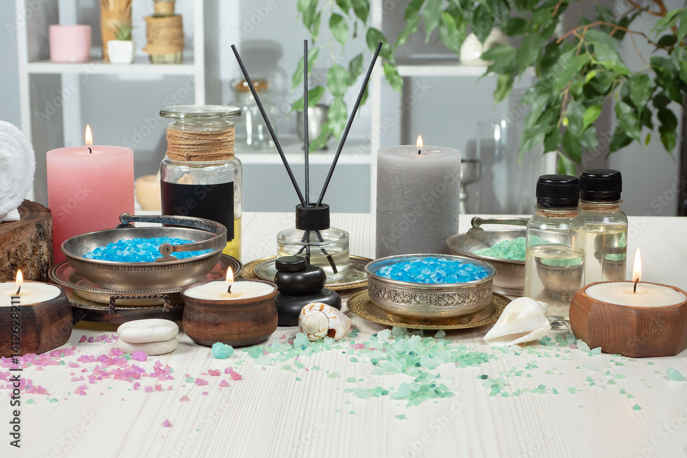 Spa treatment with candles and towel on wooden table, closeup