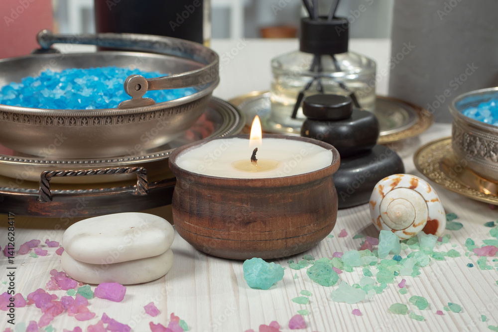 Spa treatment with candles and towel on wooden table, closeup