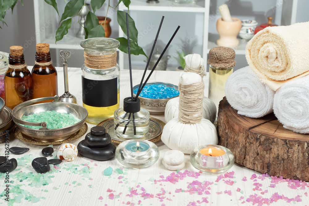 Spa treatment with candles and towel on wooden table, closeup
