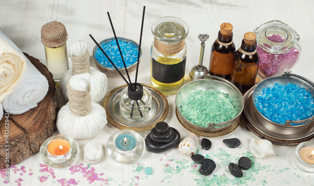 Spa treatment with candles and towel on wooden table, closeup