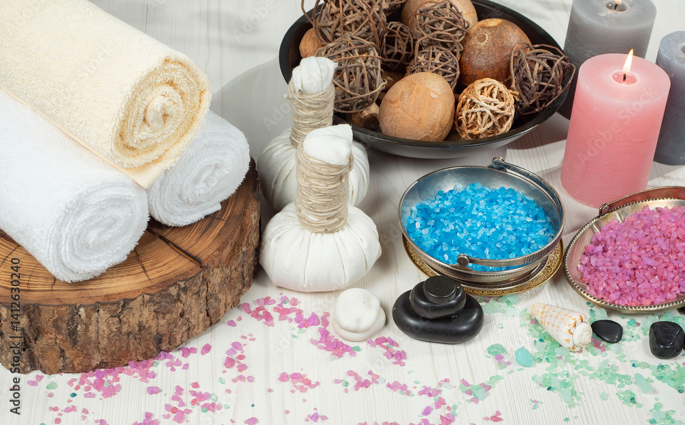 Spa treatment with candles and towel on wooden table, closeup