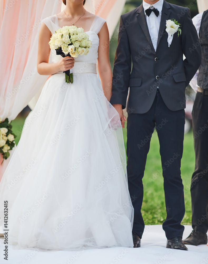 Bride and Groom Holding Hands with Bouquet Bride and Groom Holding Hands with Bouquet