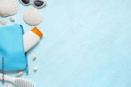 Obraz na płótnie Cosmetic bag with text MAKE UP, seashells and sunscreen on blue background w salonie