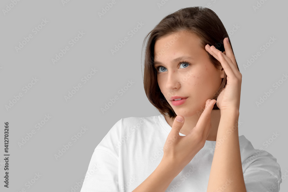 Beautiful young woman with acne problem on grey background Beautiful young woman with acne problem on grey background