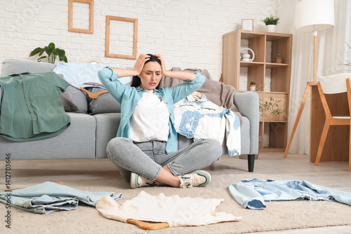 Stressed young woman choosi...