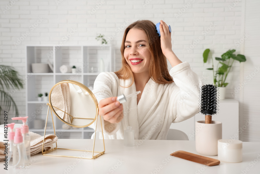 Young woman with serum using hair scalp massager at home Young woman with serum using hair scalp massager at home