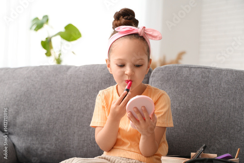 Cute little girl applying l...