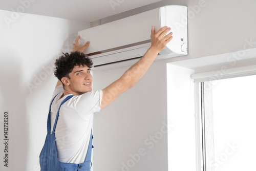 Male worker repairing air c...