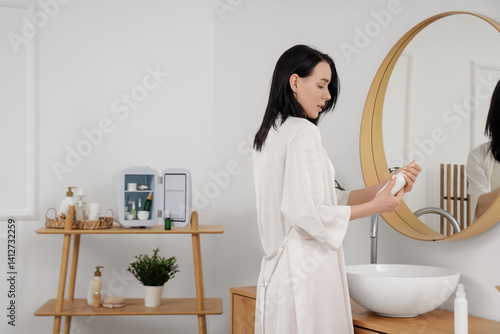 Young woman washing hands n...