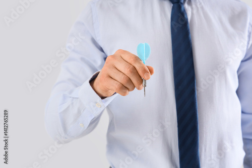 Businessman with dart on li...