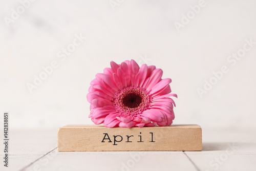 Wooden block with word APRI...