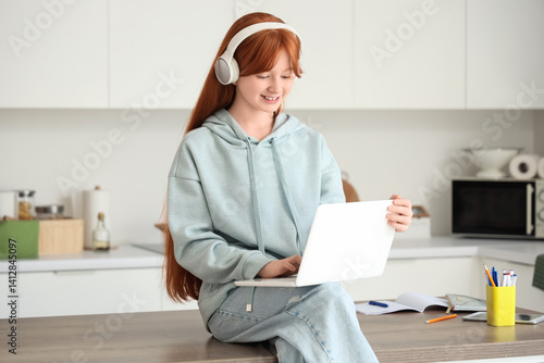 Little redhead girl with la...