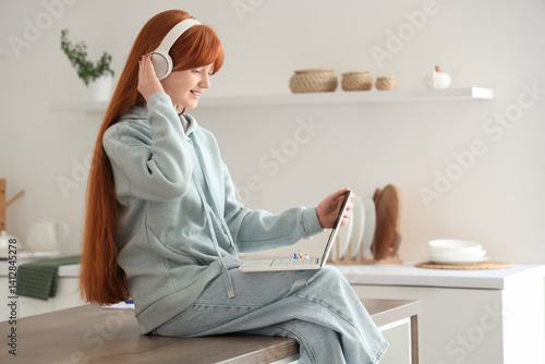 Little redhead girl with la...