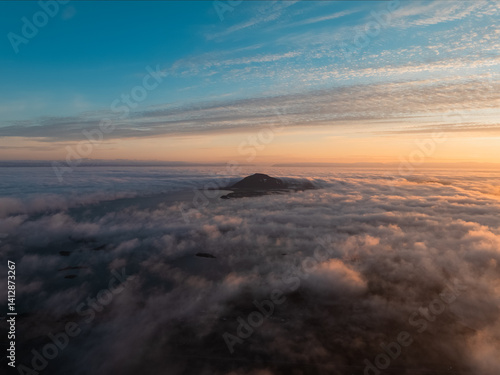 Obraz na płótnie View from above, stunning aerial view of Hverfjall volcano at sunset surrounded by beautiful fluffy clouds. Hverfjall is a fascinating volcano in Northern Iceland, near Lake Mývatn w salonie