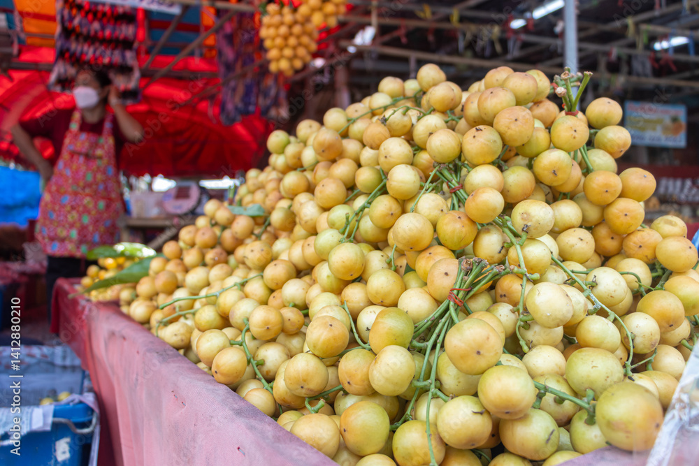 Pile of tropical fruit Burmese grapes, at the market, Thailand