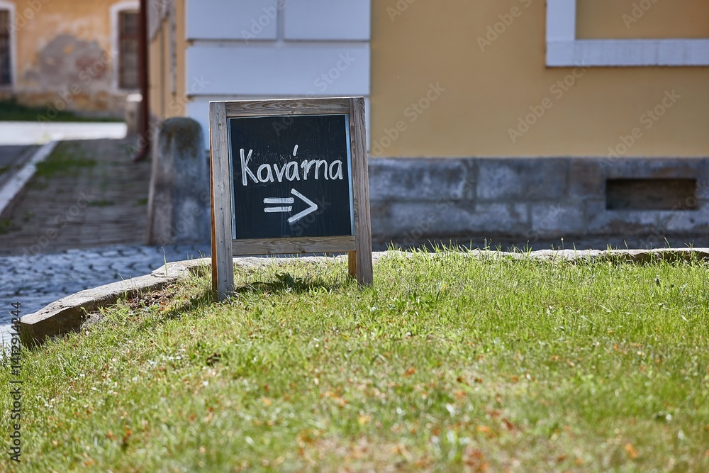 Signboard for a cafe showing direction on the street