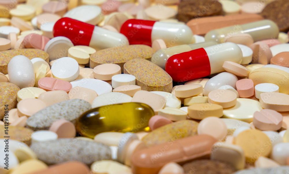 Close-up of various tablets and capsules medicines with selective focus