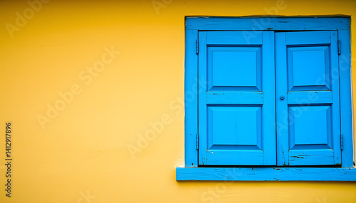 Blue window on yellow wall. with white shades