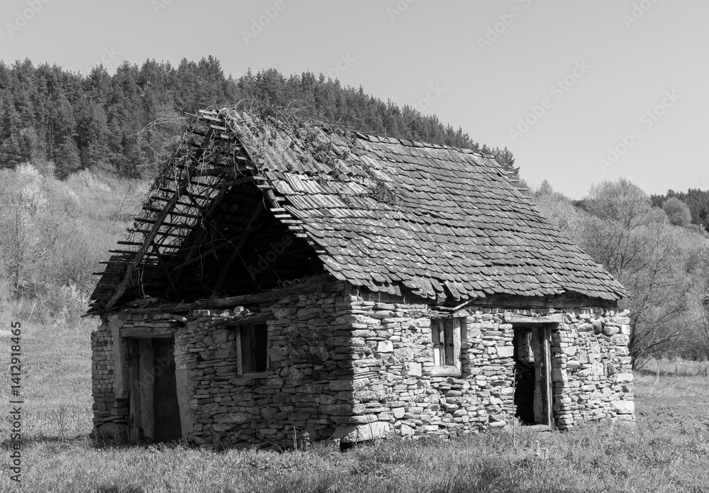 An old abandoned house made of stones in black and white
